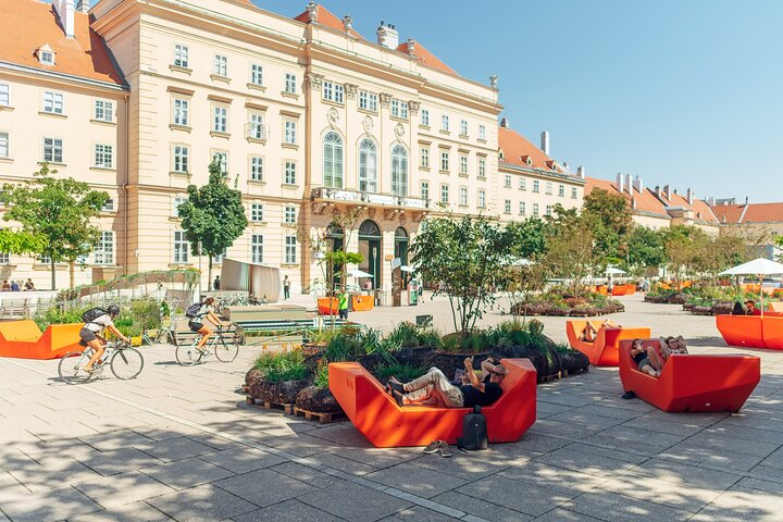 Relax in colorful seating while soaking in the unique blend of art culture and architecture at Vienna's beloved MuseumsQuartier a hub for creativity and community connection.