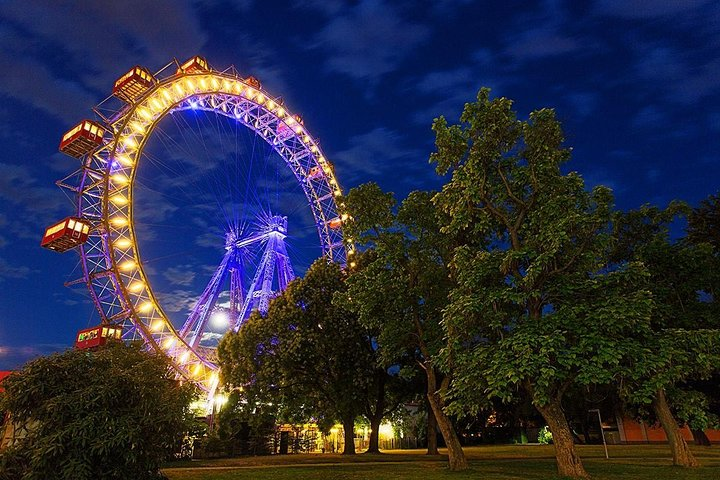 Experience stunning views from the Wiener Riesenrad as it lights up the night offering an unforgettable perspective of Vienna's skyline and iconic landmarks from 212 feet above.