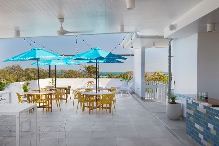 Savor freshly crafted Island Fresh Beers on a serene patio overlooking Moreton Bay where lush scenery meets delightful flavors for an unforgettable tasting adventure.