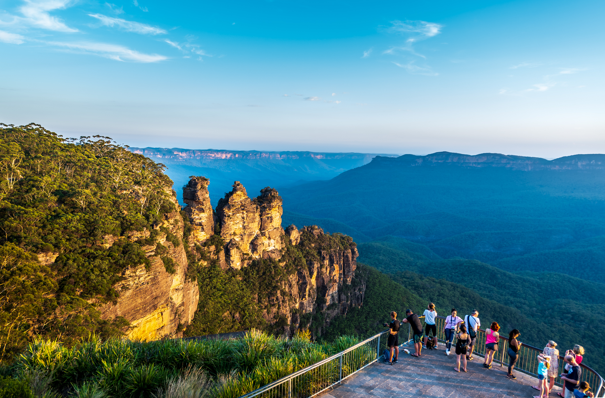 Experience the stunning views of the iconic Three Sisters illuminated by the late afternoon sun while exploring lush trails and hidden waterfalls in the Blue Mountains. Perfect for nature lovers!