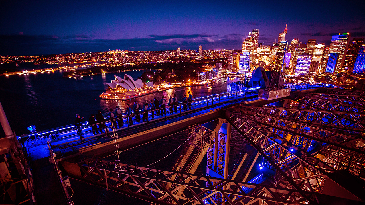 Experience the breathtaking panorama of Sydney Harbour as the city lights come alive revealing stunning projections and art installations from a unique perspective high above.