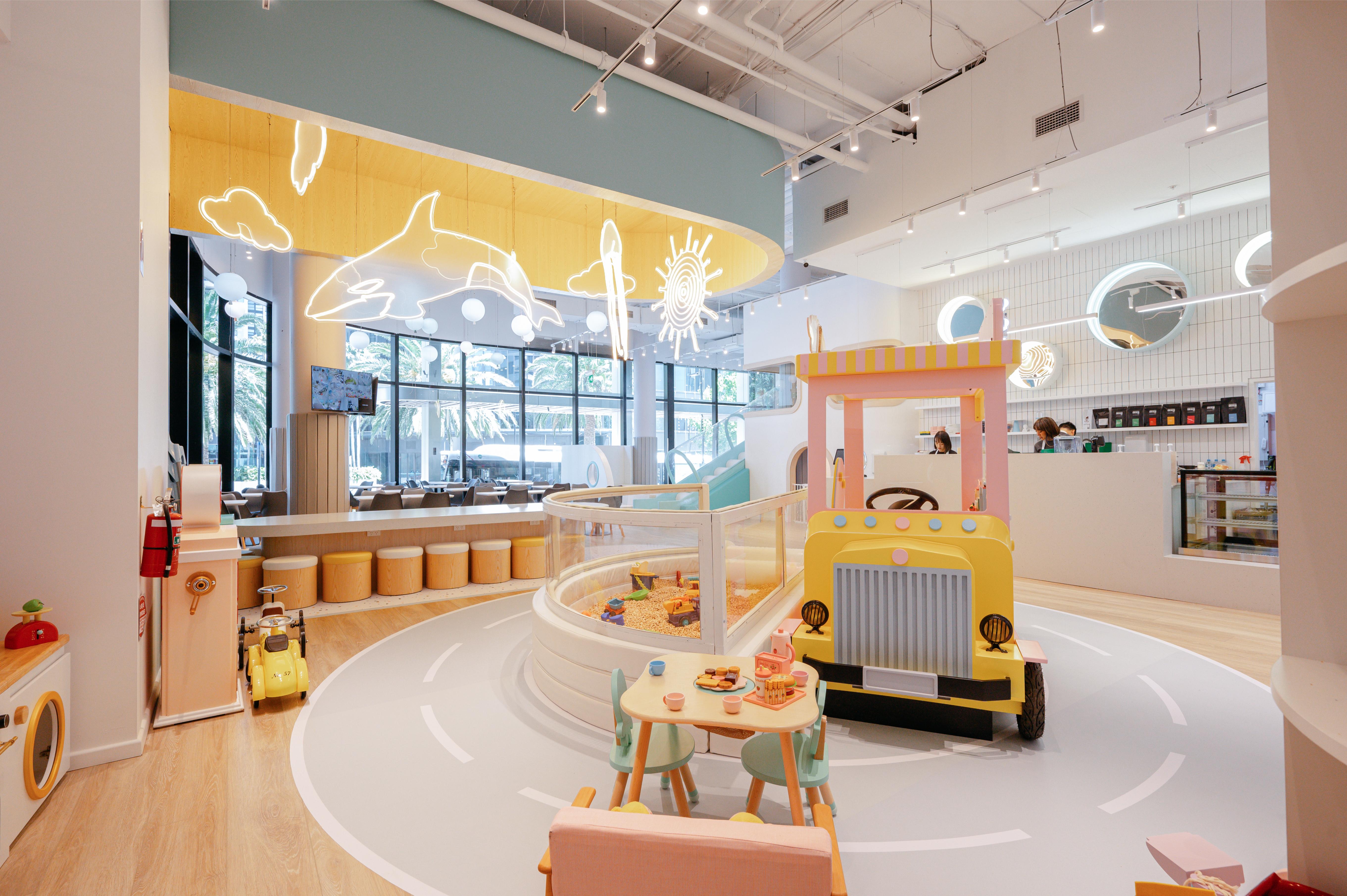 A vibrant play area invites kids to explore while parents enjoy artisanal coffee creating a joyful environment where families gather bond and share memorable moments together in Wentworth Point.