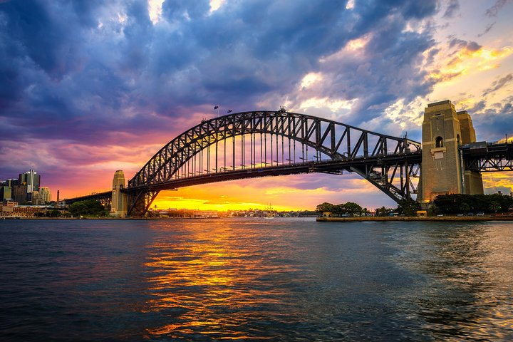Explore the stunning views beneath the Sydney Harbour Bridge where cityscapes and shimmering waters invite you to unravel clues while discovering hidden gems across Sydney.