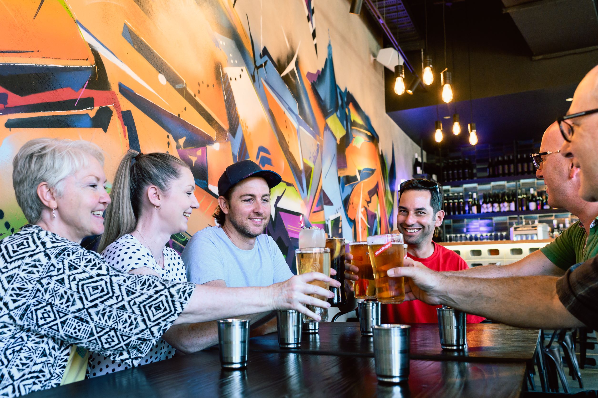 Experience Perth's local culture as you sip drinks and share stories with friends amid unique wall art exploring hidden gems while enjoying delicious food along the way.