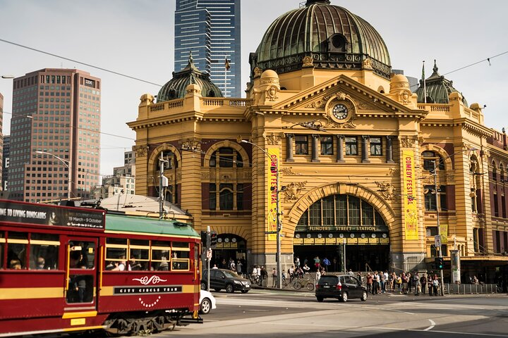 Explore the iconic Flinders St Station a perfect starting point for uncovering Melbourne's hidden gems local stories and delightful cafes as you wander through the city.