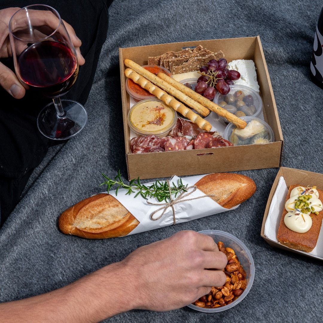 Indulge in a leisurely picnic surrounded by olive groves enjoying a delightful selection of gourmet snacks and local wine perfect for creating memorable family moments.