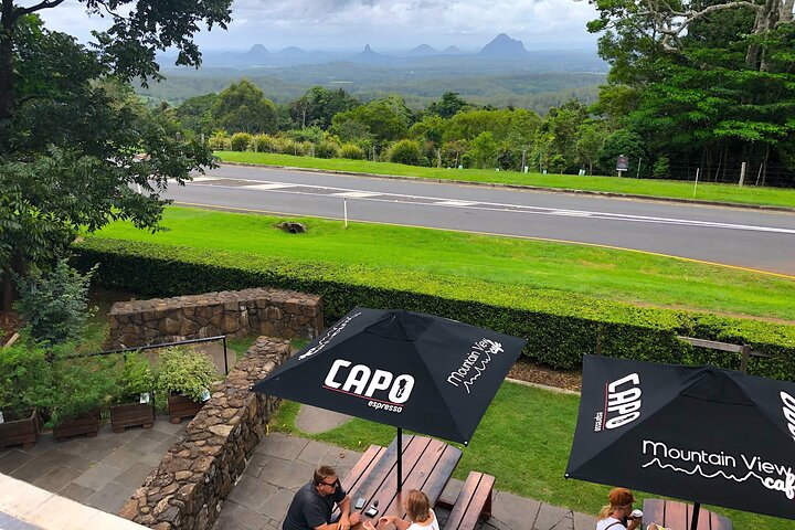 Experience breathtaking views of the Glass House Mountains while enjoying local delights. Relax at charming cafes in Montville and Maleny where art and nature blend seamlessly.
