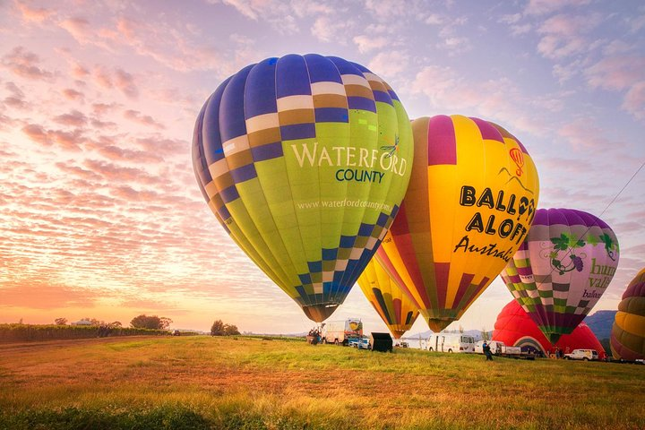 Soar above the stunning Hunter Valley at sunrise where colorful hot air balloons paint the sky offering breathtaking views and a unique perspective on this picturesque region.