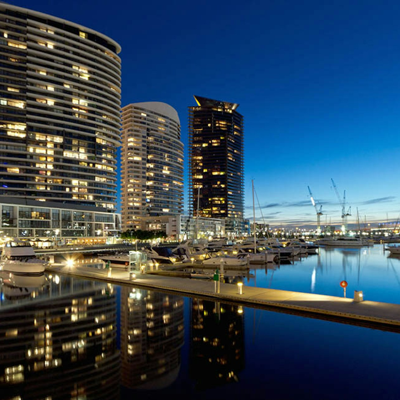 Experience Melbourne's skyline illuminated at night as city lights dance on the Yarra River. A serene setting perfect for friends romance or simply soaking in the picturesque surroundings.