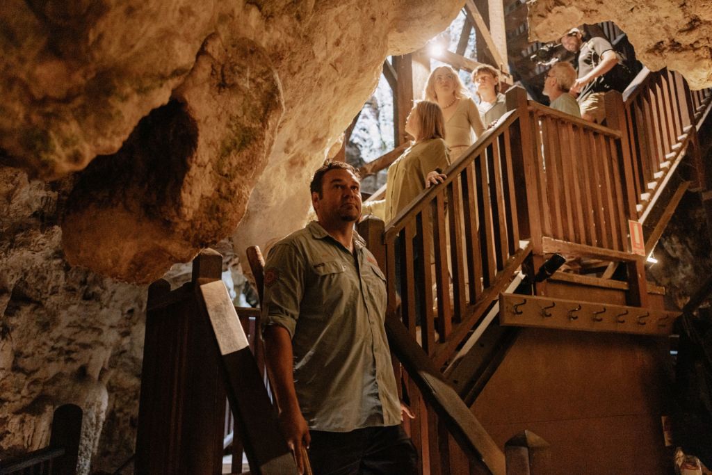 Explore the serene beauty of Ngilgi Cave with Josh Koomal Whiteland learning about traditional practices and the land's rich heritage while surrounded by stunning geological formations.