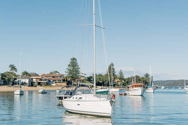 Experience serene waterside moments aboard a Beneteau yacht surrounded by picturesque Palm Beach scenery. Enjoy relaxing nights and savor delicious platters while soaking in the tranquil Sydney landscape.