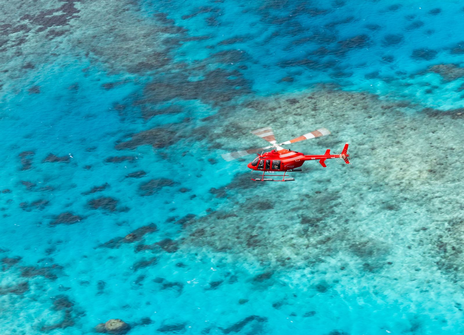 Experience breathtaking aerial views of the Great Barrier Reef with its stunning coral formations and crystal-clear waters while gliding effortlessly above this natural wonder. An unforgettable adventure awaits.