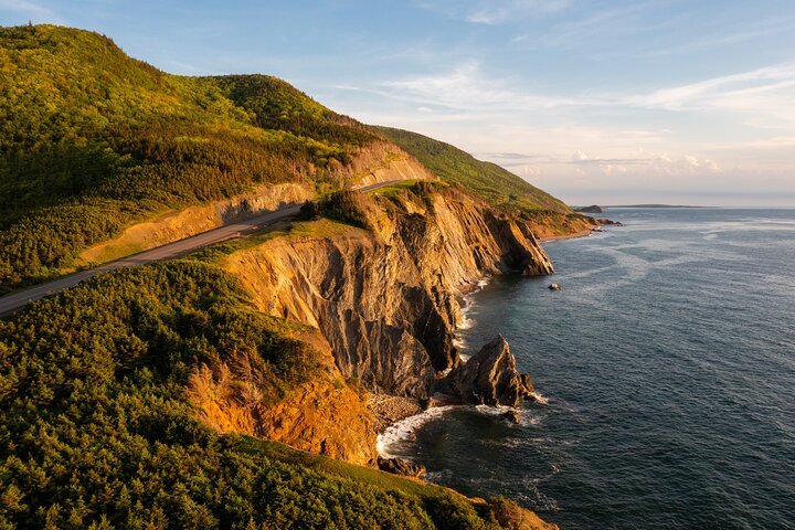 Journey along the Cabot Trail where rugged cliffs meet the sea revealing stunning coastlines and lush forests that showcase Cape Breton's natural beauty and maritime heritage.