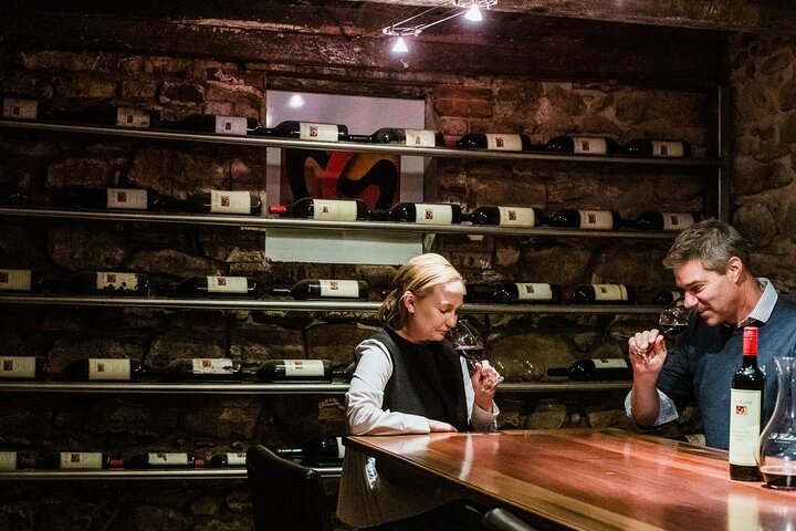 Experience a moment of indulgence in the cellar savoring exquisite Shiraz selections while enjoying a delicious regional platter amidst the charming rustic backdrop of Barossa Valley.