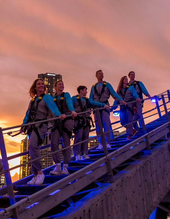 Experience breathtaking views of Brisbane as you climb the iconic Story Bridge at twilight surrounded by stunning cityscapes and a memorable adventure with friends.