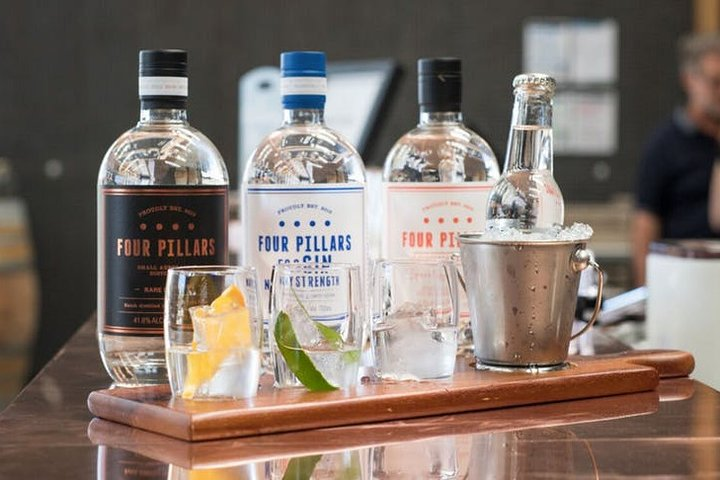 Indulge in a delightful gin tasting experience at Four Pillars complemented by exquisite local cuisine in Yarra Valley's stunning wine landscape perfect for creating memorable moments with friends.