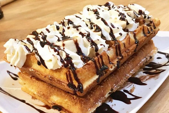 Indulge in the joy of crafting your own Belgian waffles complete with delightful toppings and friendly camaraderie making for a memorable culinary experience in the heart of Brussels.
