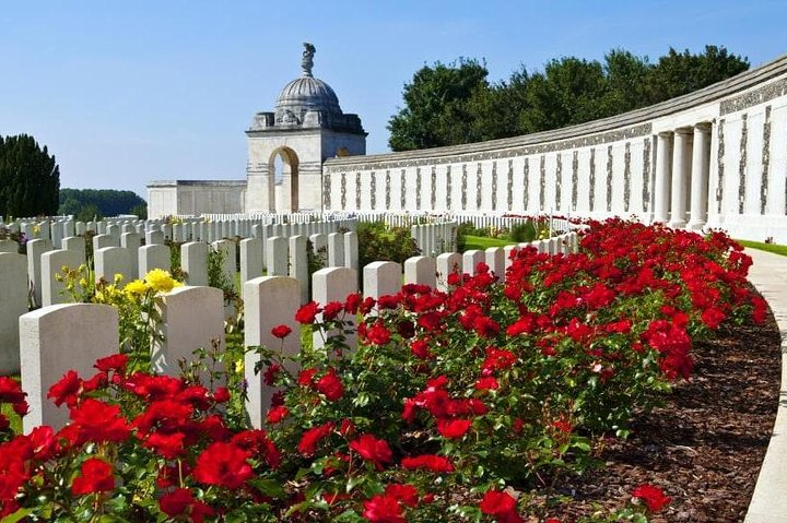 Reflect on the serene beauty of Flanders as you explore memorials adorned with vibrant flowers honoring the profound sacrifices of soldiers amid the tranquil Belgian landscape.