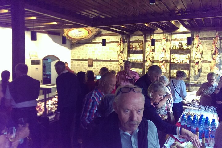 Tasting local wine and cured meat delicacies.