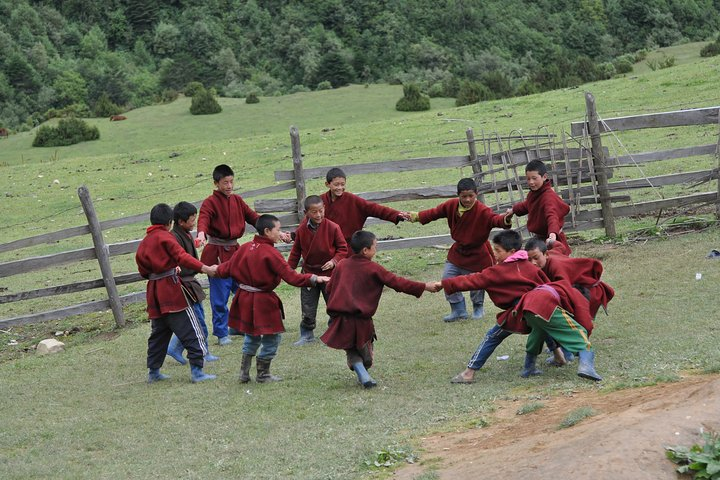 Dressed in their traditional costume, young students of Merak Village playing during the school break.