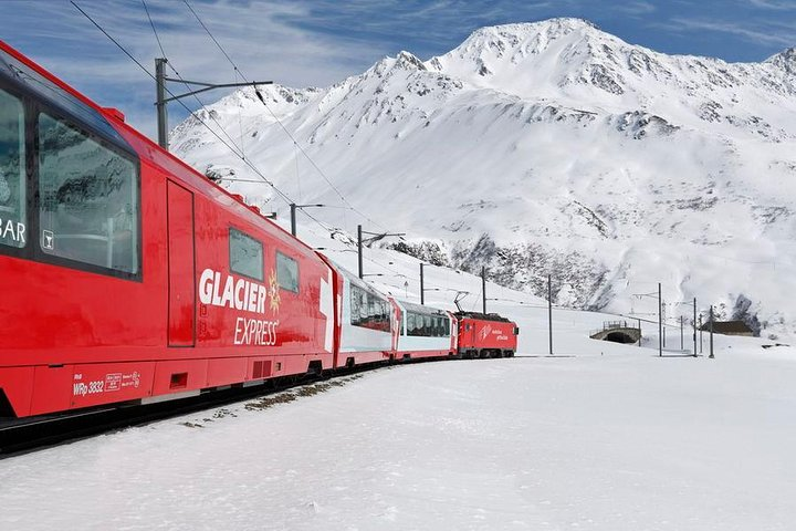 Experience the stunning Alpine landscapes aboard the Glacier Express where snow-capped mountains and serene valleys unfold outside your window all while enjoying a gourmet lunch with expert guidance.