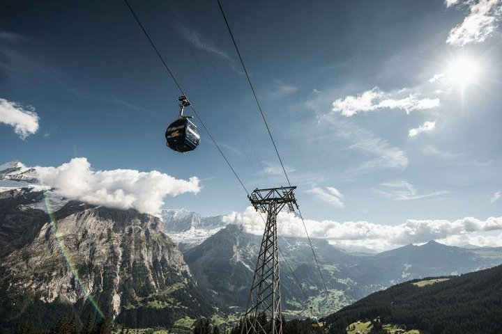 Breathtaking views of the Swiss Alps unfold as the cable car ascends transporting travelers into a realm of stunning landscapes and adventure just waiting to be explored.