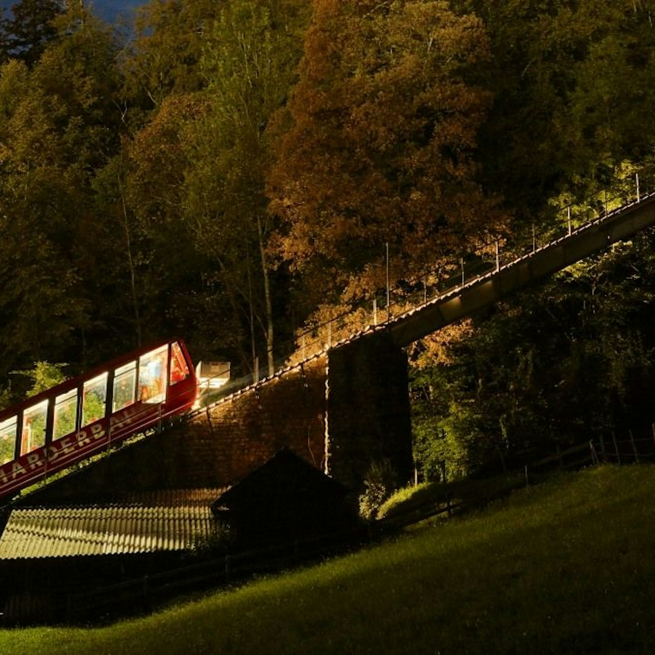 Glide into the night on the Harder Kulm funicular - a steep, glowing climb that takes you from Interlaken to sweeping views of the Jungfrau Region.