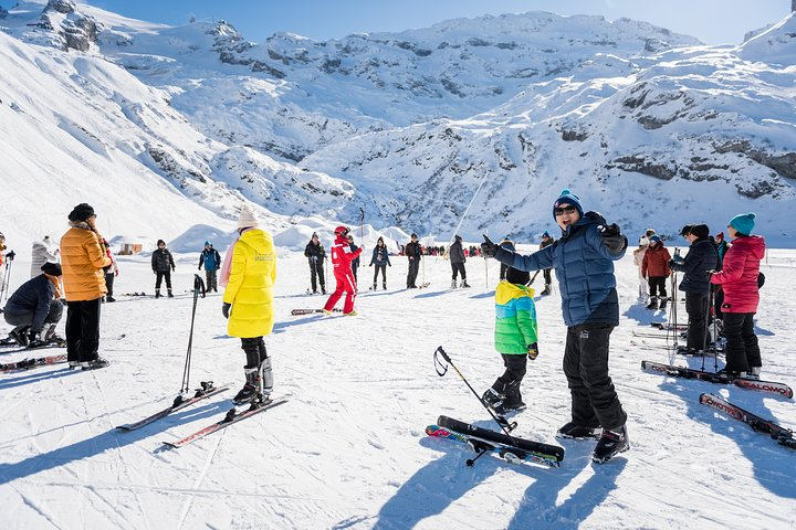 Breathe in the crisp mountain air while enjoying a fun-filled day on the slopes where beginners take their first steps in skiing amidst the stunning Swiss Alps scenery.
