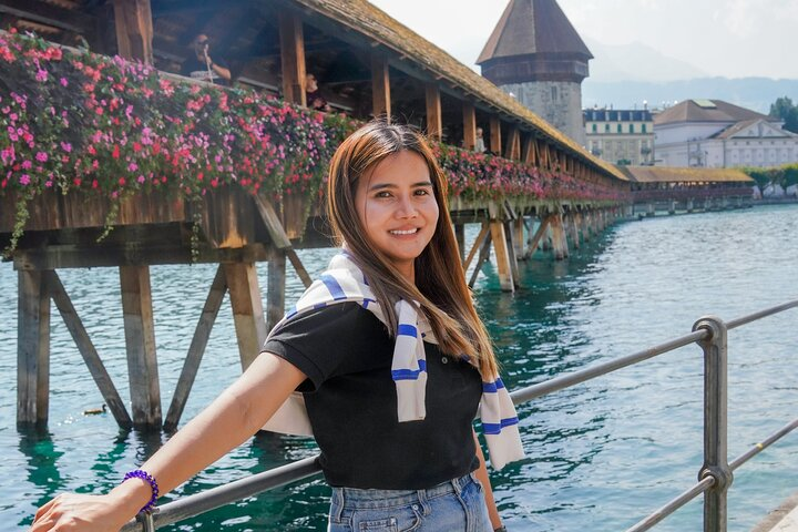 Experience a delightful stroll along Lucerne's iconic Chapel Bridge where stunning views and charming scenery create the perfect backdrop for memorable photos and local insights. Enjoy your adventure!