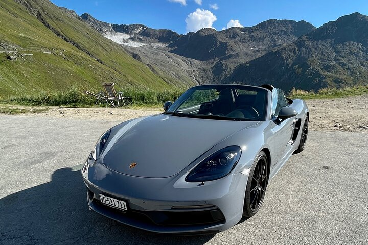 Experience the stunning contrasts of the Swiss Alps as you navigate the legendary Stelvio Pass in a sleek Porsche surrounded by breathtaking mountain vistas and pristine landscapes.