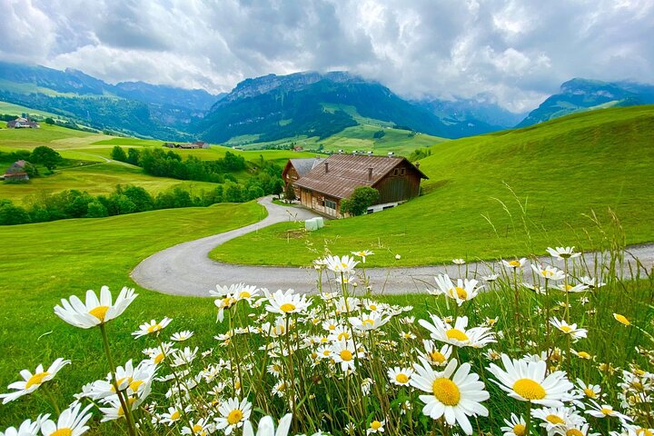 Experience the charm of a Swiss farm surrounded by lush meadows and majestic mountains where you can connect with nature and enjoy delicious local cheese fondue amidst stunning views.