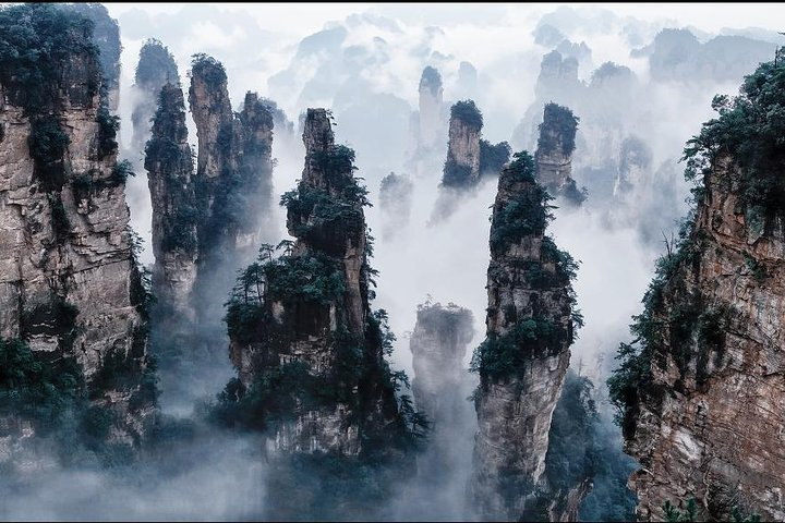 Explore Zhangjiajie’s iconic rock formations shrouded in mist an unforgettable setting that inspired cinematic landscapes. Nature's majesty awaits on this immersive 3-day adventure.