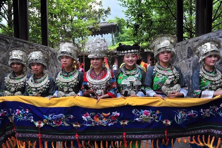 miao minority girl welcoming guests