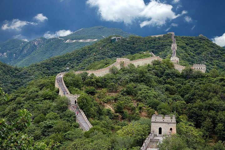 Explore the majestic Mutianyu section of the Great Wall surrounded by lush greenery and stunning vistas ensuring a memorable journey through history and breathtaking scenery.