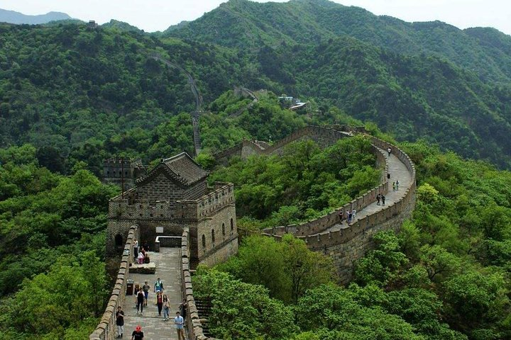 Explore the stunning expanse of the Great Wall meandering through lush landscapes and past historic watchtowers creating unforgettable memories alongside fellow travelers.