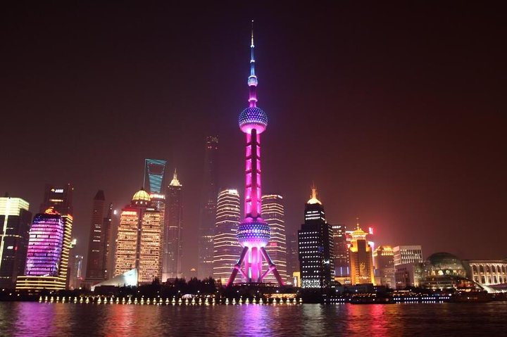 Immerse yourself in the stunning skyline of Shanghai where illuminated skyscrapers reflect on the Huangpu River creating a breathtaking backdrop for an unforgettable nighttime cruise along The Bund.