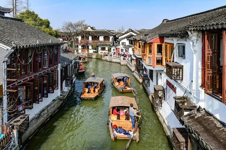 Explore the charm of Zhujiajiao Water Town with its serene canals and traditional wooden boats while enjoying the lively morning scenes in Shanghai’s historic French Concession.