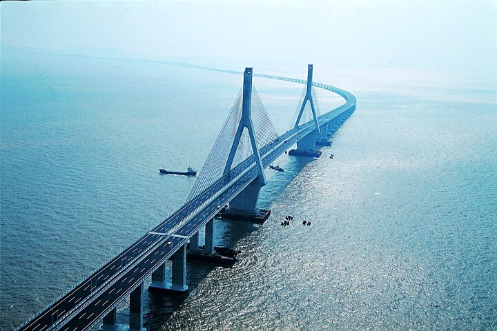 Experience the stunning Donghai Bridge stretching over shimmering waters connecting you to the serene beauty of Yangshan Island and the tranquil Dishui Lake perfect for exploration and relaxation.