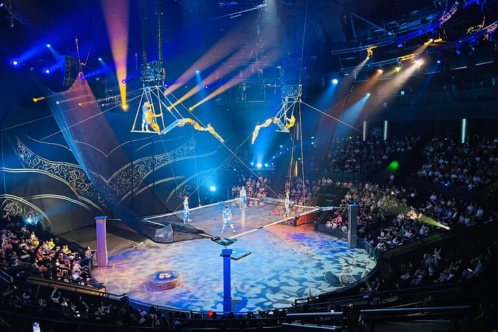 Experience the magic of Shanghai's acrobatics as performers defy gravity amidst dazzling lights and stunning effects creating unforgettable moments for all ages at the iconic ERA Theatre.
