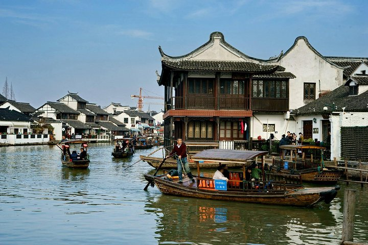 Explore the charm of Zhujiajiao Ancient Town with traditional sculling boat rides through serene waterways historic bridges and delightful local shops creating a unique cultural journey.