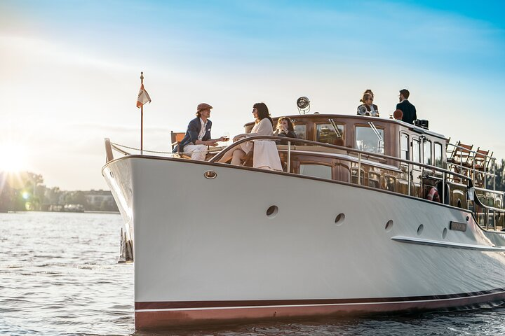 Experience the serene beauty of Berlin's landmarks aboard a fully electric vintage yacht where elegant comfort and eco-friendly travel create lasting memories as you glide through the city's waterways.