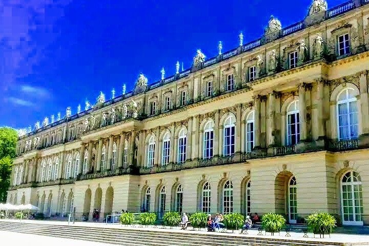 Discover the grandeur of Herrenchiemsee Palace surrounded by stunning lake views and lush landscapes offering travelers a unique blend of history and beauty in Bavaria.