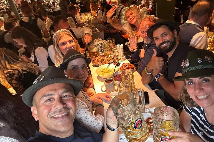 Everyone raises their glasses and shouts “Prosit!”