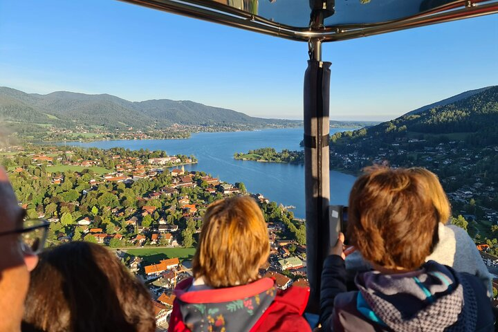 Experience stunning views of Lake Tegernsee from above surrounded by lush greenery and charming villages. Perfect for travelers seeking a unique blend of nature and local culture.
