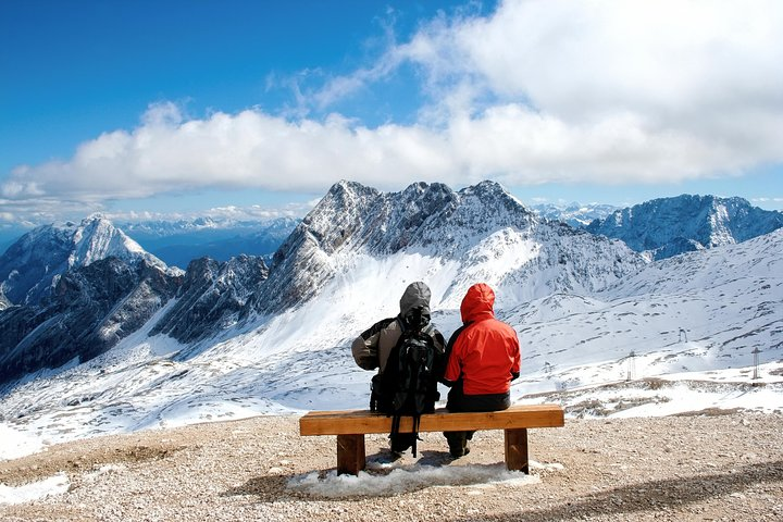 A breathtaking panorama reveals Germany's highest peaks inviting travelers to soak in stunning views and create unforgettable memories at Zugspitze where nature and adventure come together.