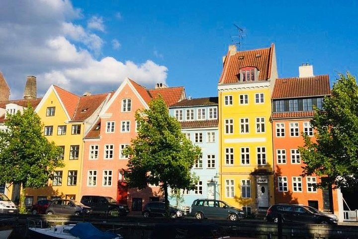Discover Copenhagen's charm as you stroll past colorful buildings along picturesque canals culminating in a delicious taste of traditional Smorrebrod at a cozy local eatery.