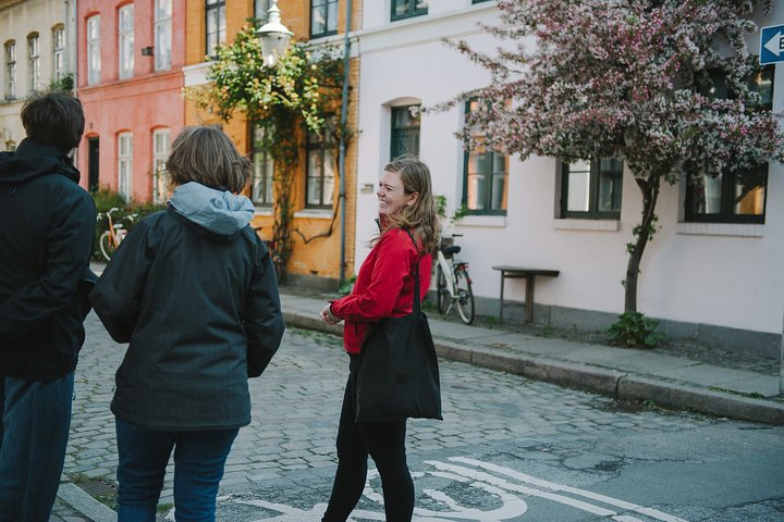 Discover cozy streets lined with charming houses and blooming trees inviting you to explore the heart of Copenhagen's hygge. Embrace the warmth of local culture and treasured experiences.