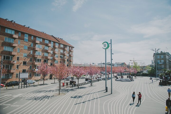 Nørrebro invites exploration with its cherry blossoms and vibrant urban design perfect for wandering through delightful shops and discovering eclectic eateries. Immerse yourself in the neighborhood's unique charm.