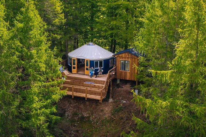 Experience the tranquility of nature from a cozy insulated yurt complete with stunning views and modern comforts. Perfect for a relaxing getaway amidst lush greenery and serene waters.