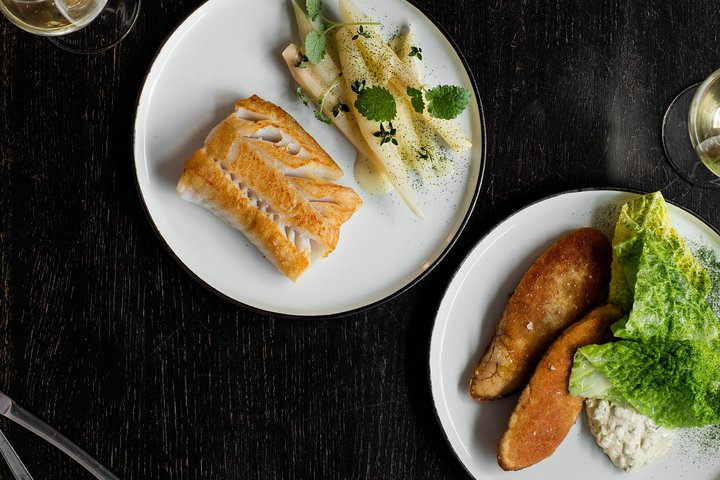 Savor exquisite local dishes paired with refreshing beverages as you explore Copenhagen's culinary scene on a delightful walking tour focused on food culture and community.